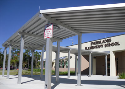 large flat aluminum canopy system in front of school