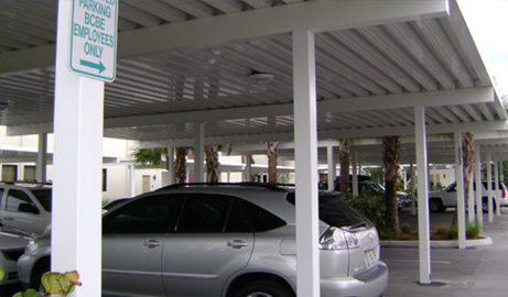 car protected from the weather by an aluminum carport
