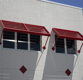 red sunshades constructed above windows